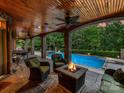 Cozy outdoor patio featuring comfortable seating, a fire pit, and a view of the pool, perfect for relaxation at 4290 Barbrick St, Sherrills Ford, NC 28673