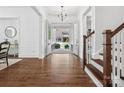 Grand foyer with hardwood floors, a staircase, and elegant chandelier create a warm and inviting atmosphere at 435 Galbreath Ct # 128, Fort Mill, SC 29708
