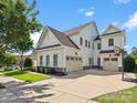Rear exterior view of a white home with a three car garage and basketball hoop on a large concrete driveway at 435 Galbreath Ct # 128, Fort Mill, SC 29708