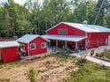 Red barn-style home with well-maintained landscaping and separate accessory building at 574 Crescent Rd, Rockwell, NC 28138