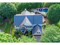 Aerial view of a two-story home with a pool in the backyard surrounded by lush landscaping at 6206 Glencairn Ct, Charlotte, NC 28269