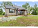 Inviting single-story home featuring a brick porch, decorative front door, and well-manicured lawn at 632 Skyland N Dr, Mount Pleasant, NC 28124