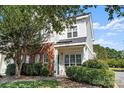 Well-maintained two-story home with brick accents, manicured bushes and a neatly kept front lawn at 6443 Mallard View Ln, Charlotte, NC 28269
