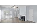 Bright, open living room features wood floors, fireplace, ample natural light, and neutral paint at 6443 Mallard View Ln, Charlotte, NC 28269