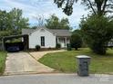 Lovely white home with a covered carport and well-maintained lawn on a sunny day at 6507 Chewink Ct, Charlotte, NC 28227