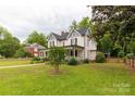 Quaint two-story house is nestled amongst lush greenery with a well-maintained lawn and welcoming facade at 7 Kings Mountain St, York, SC 29745