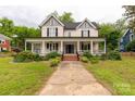 Lovely two-story home features a wide front porch and classic architectural elements in a landscaped setting at 7 Kings Mountain St, York, SC 29745