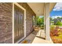 Covered porch with brick, stylish seating, and a welcoming front door at 700 Windage Way, Pineville, NC 28134