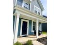 Inviting front porch with white pillars and dark siding, offering a cozy outdoor seating area at 7024 Wheyfield Dr, Charlotte, NC 28215