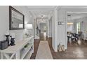 Elegant hallway featuring hardwood floors, decorative lighting, and neutral paint scheme at 7331 Millstone Sw Cir, Concord, NC 28025