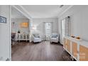 Bright living room with hardwood floors, stylish furniture, and ample natural light at 7331 Millstone Sw Cir, Concord, NC 28025