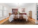 Formal dining room with hardwood floors, classic furniture, and elegant chandelier at 800 Davenport St, Monroe, NC 28112
