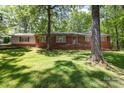 Beautiful traditional style brick home with lovely front yard and mature trees at 800 Davenport St, Monroe, NC 28112