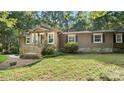 Attractive home featuring a cozy front porch and a well-kept lawn, inviting you to relax outdoors at 8321 Walkup Rd, Waxhaw, NC 28173
