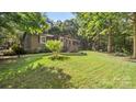 Quaint home with lush green lawn and mature trees creating a serene and private outdoor space at 8321 Walkup Rd, Waxhaw, NC 28173