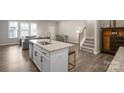 Charming kitchen island with granite countertops, seating, and modern fixtures at 8928 Morning Mist Rd, Charlotte, NC 28215