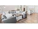 Comfortable living room featuring a large sectional sofa and stylish decor at 8928 Morning Mist Rd, Charlotte, NC 28215