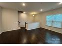 Cozy living room showcasing hardwood floors, recessed lighting, and staircase to upper level at 9236 Ainslie Downs St, Charlotte, NC 28273