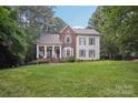 Charming two-story home with a welcoming front porch and manicured lawn at 134 Lake Spring Loop, Mooresville, NC 28117