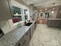 Beautiful kitchen featuring granite counters, stainless steel sink, and a view to the living room at 410 Gann St, Lowell, NC 28098