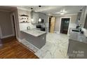 Modern kitchen with granite countertops, stainless steel appliances, and an eat-in island at 410 Gann St, Lowell, NC 28098