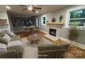 Bright, open living room features hardwood floors, fireplace, and an open layout into the dining area at 410 Gann St, Lowell, NC 28098
