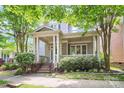 Beautiful home with a welcoming covered porch, brick accents, and lush greenery in a desirable neighborhood at 7023 Blakeney Greens Blvd, Charlotte, NC 28277