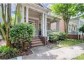Inviting home with a classic covered porch, brick stairs, mature landscaping, and a sense of neighborhood charm at 7023 Blakeney Greens Blvd, Charlotte, NC 28277