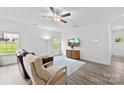 Bright living room with hardwood floors, a comfortable seating area, and a large window showcasing the outdoor view at 104 E Louisiana Ave, Bessemer City, NC 28016