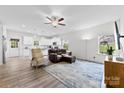 Open-concept living space features hardwood floors, modern ceiling fan, with abundant natural light and neutral paint at 104 E Louisiana Ave, Bessemer City, NC 28016