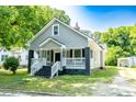 A beautiful view of the home showcasing its well-maintained landscaping, inviting front porch, and architectural details at 112 Hampton St, Chester, SC 29706