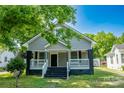 Quaint home with gray siding, a covered front porch, and classic black accents creating a warm, inviting curb appeal at 112 Hampton St, Chester, SC 29706