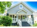 Charming home featuring gray siding, a covered front porch, and classic black accents creating inviting curb appeal at 112 Hampton St, Chester, SC 29706
