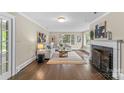 Bright living room features a fireplace, hardwood floors, and large windows with natural light at 121 33Rd Ne Ave, Hickory, NC 28601