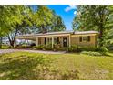 Charming brick home with a covered carport and meticulously maintained landscaping at 141 Dunlap Loop, Statesville, NC 28625