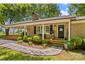 Charming brick ranch home with a cozy front porch and meticulously maintained landscaping at 141 Dunlap Loop, Statesville, NC 28625