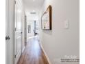 Hallway featuring wood flooring, white walls, and doors, illuminated by recessed lighting at 1511 River Cane St, Edgemoor, SC 29712