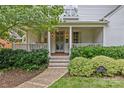 Inviting front porch with classic columns, brick steps, and professional landscaping at 2814 Glendale Rd, Charlotte, NC 28209