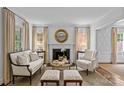 Elegant living room featuring a fireplace, neutral color palette, and ample natural light at 2814 Glendale Rd, Charlotte, NC 28209