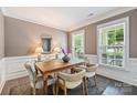 Well-lit dining room with a wooden table and neutral-toned walls at 2844 Georgia Ave, Charlotte, NC 28205