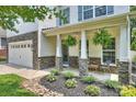 Beautiful two-story home showcasing stone accents, white siding, blue shutters, and a well-manicured lawn at 2844 Georgia Ave, Charlotte, NC 28205