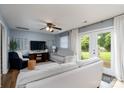 Cozy living room with neutral walls, ceiling fan, and a door leading to the backyard at 318 Confederate Sw Dr, Concord, NC 28027