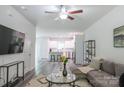 Comfortable living room with modern furnishings, a ceiling fan, and gray wood flooring throughout the home at 3403 Keith Dr, Charlotte, NC 28269