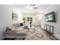 Cozy living room with large window, modern furnishings, stylish rug, and gray wood flooring throughout the home at 3403 Keith Dr, Charlotte, NC 28269