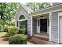 Close up of front door with brick trim and well-maintained front yard landscaping at 3826 Yorkford Dr, Charlotte, NC 28269
