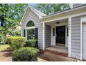 Inviting front entrance with neatly trimmed bushes, house number, and covered porch at 3826 Yorkford Dr, Charlotte, NC 28269