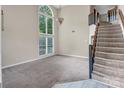 Bright living room with large windows, high ceilings, and elegant chandelier at 3826 Yorkford Dr, Charlotte, NC 28269