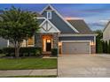 Charming two-story home with stone accents, a well-manicured lawn, and a convenient two-car garage at 4049 Shadowbrook Rd, Waxhaw, NC 28173