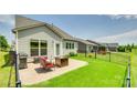 Backyard featuring a paver patio with outdoor furniture and a grill, grass, and a fenced perimeter at 4511 Middlebury Ln, Fort Mill, SC 29715