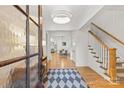 Bright foyer with hardwood floors, decorative rug, and an open staircase at 6013 Camile Ct, Charlotte, NC 28226